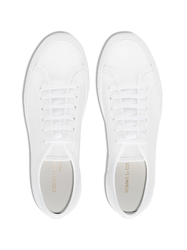 woman by common projects white tournament low super sneakers