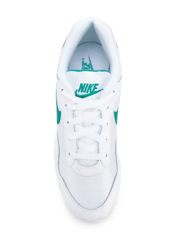nike outburst trainers in white and green