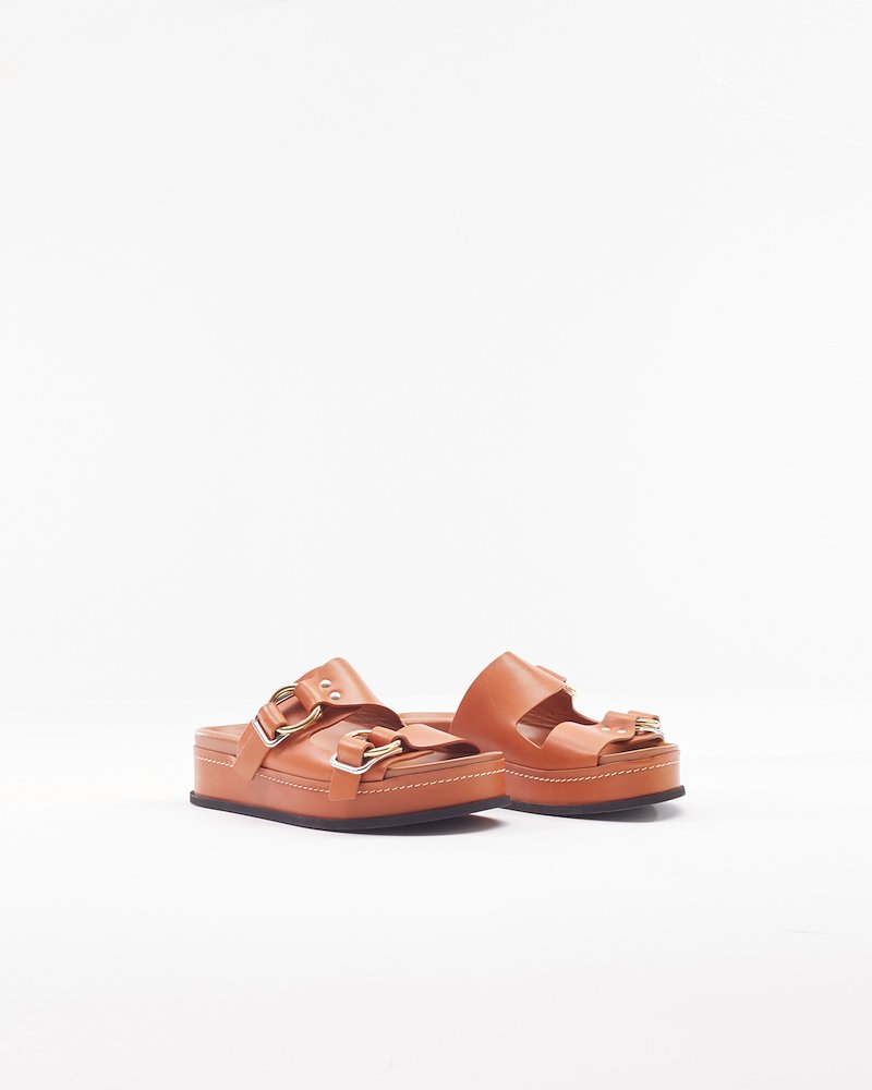 Freida Double-Buckle Platform Slide-brown #1 Freida Double-Buckle Platform Slide, Cognac brown calf leather Freida double-buckle platform slides from 3.1 Phillip Lim featuring open toe, slip-on style, branded insole, buckle fastening and flatform sole.- 1