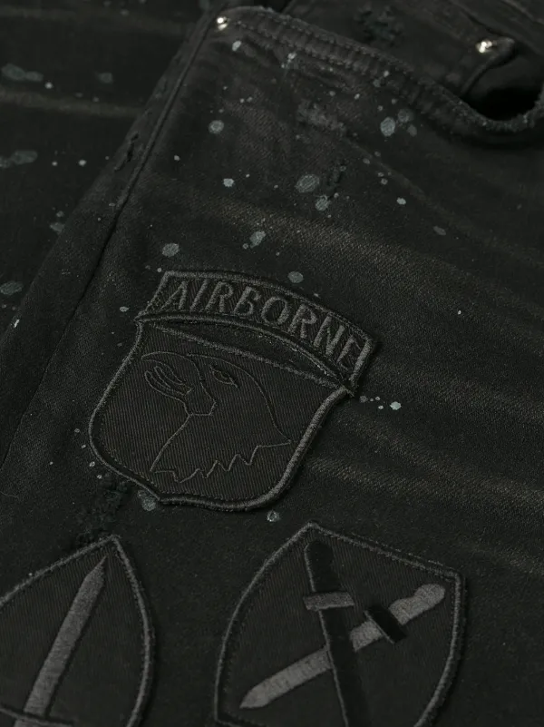 black amiri jeans with patches
