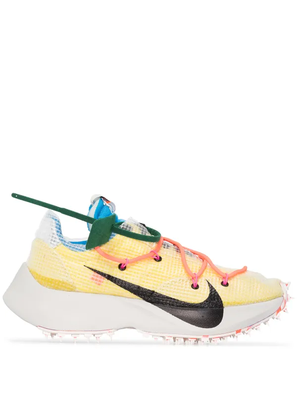 white and yellow nike shoes