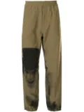 Undercover A Clockwork Orange print track pants - Green