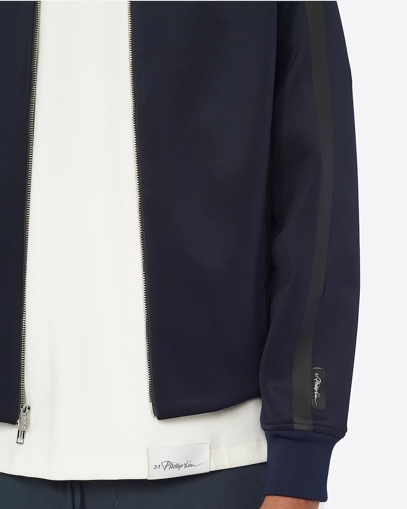 Track Jacket-blue #1 Track Jacket, Athleisure just got cooler! This track jacket from 3.1 Phillip Lim is a streetwear staple that can be perfect to transitioning into seasons. Spend your all day in supreme comfort. Featuring a funnel neck, a front zip fastening, long sleeves, ribbed cuffs, logo patch on the sleeve and contrast piping. POSITIVELY CONSCIOUS: This product is made with a certified eco-material or a recycled material that is better for the planet, so you can be confident you are choosing positively.- 3