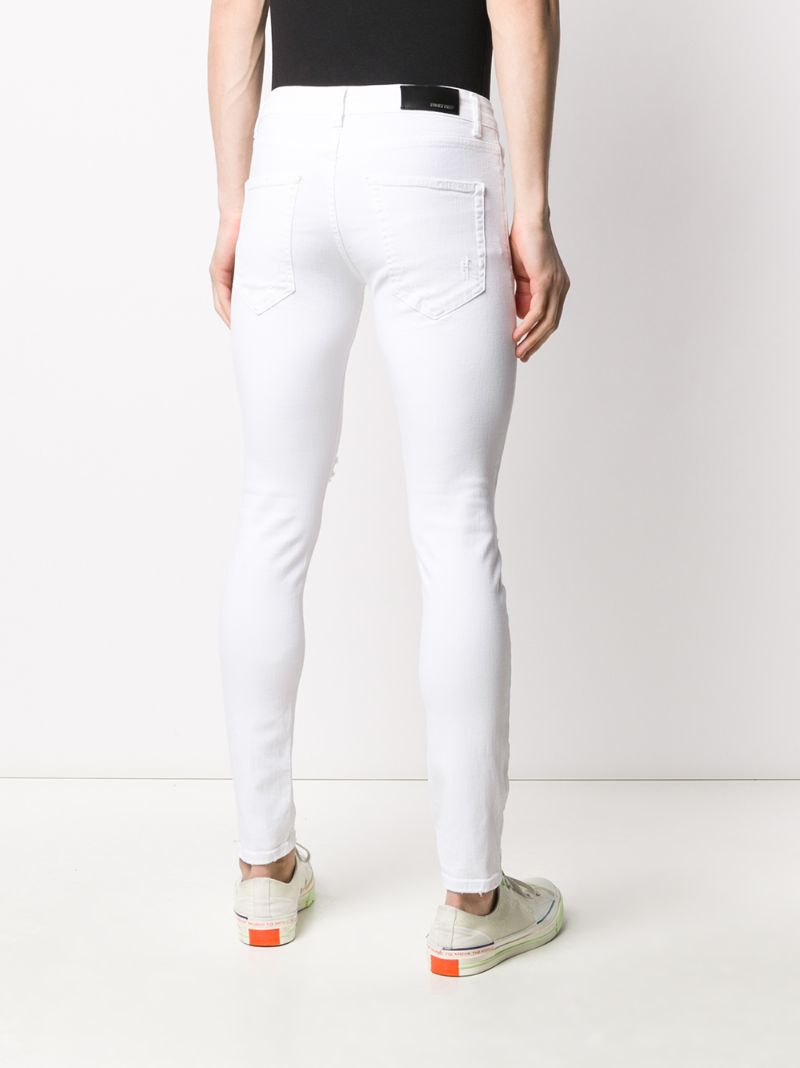 Shop Family First Distressed Skinny Jeans In White