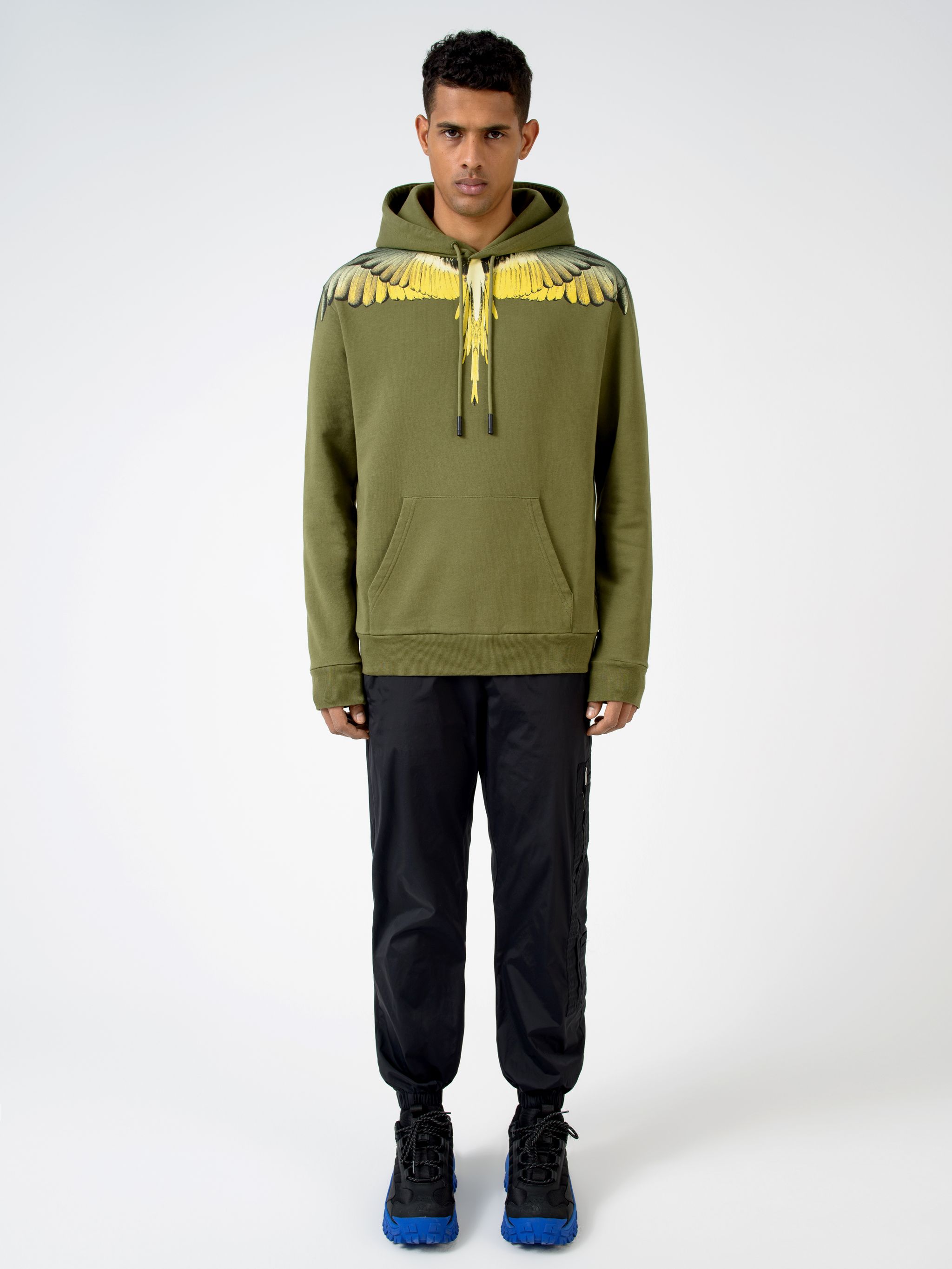 Army green/yellow cotton winged shoulder hoodie from Marcelo Burlon County of Milan featuring drawstring hood, feather print, front pouch pocket, long sleeves and ribbed detailing.