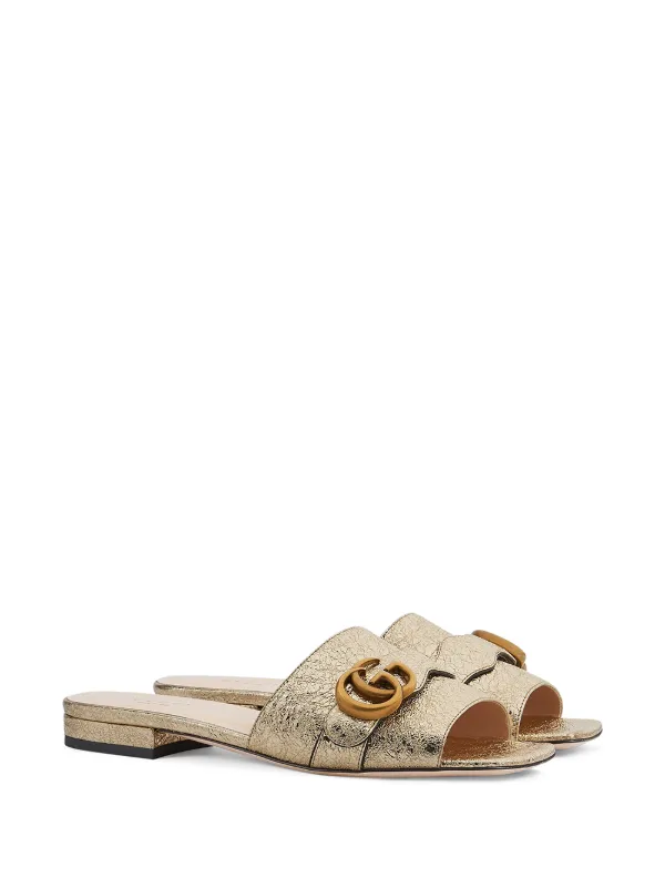 brown and gold gucci slides