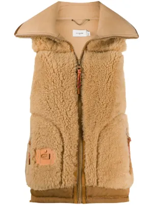 shearling logo-patch gilet by Coach, available on farfetch.com for $2102 Jennifer Lopez Outerwear SIMILAR PRODUCT