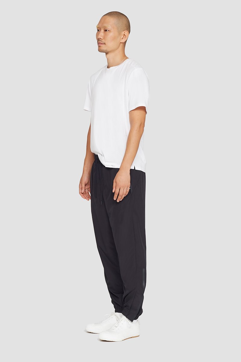 The Track-Less Pants-black #1 The Track-Less Pants, Black Track-Less pants from 3.1 PHILLIP LIM featuring tapered leg, elasticated drawstring waistband, two side slit pockets, rear welt pocket, zip details and elasticated ankles.- 1