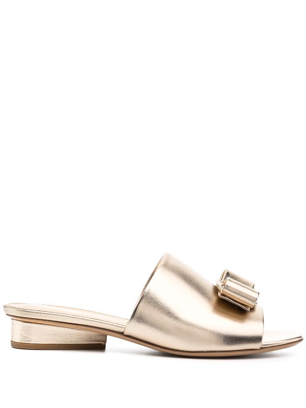 white and gold ferragamo slides