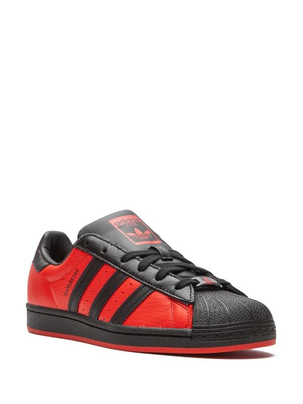 Shop adidas SuperStar J sneakers with 