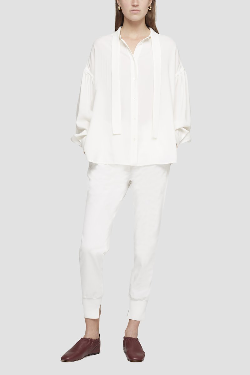 Tie Waist Utility Jogger-white #0 Tie Waist Utility Jogger, White cotton tapered track pants from 3.1 PHILLIP LIM featuring drawstring fastening waist, pleat detailing, two side slit pockets, tapered leg and tonal design.- 0