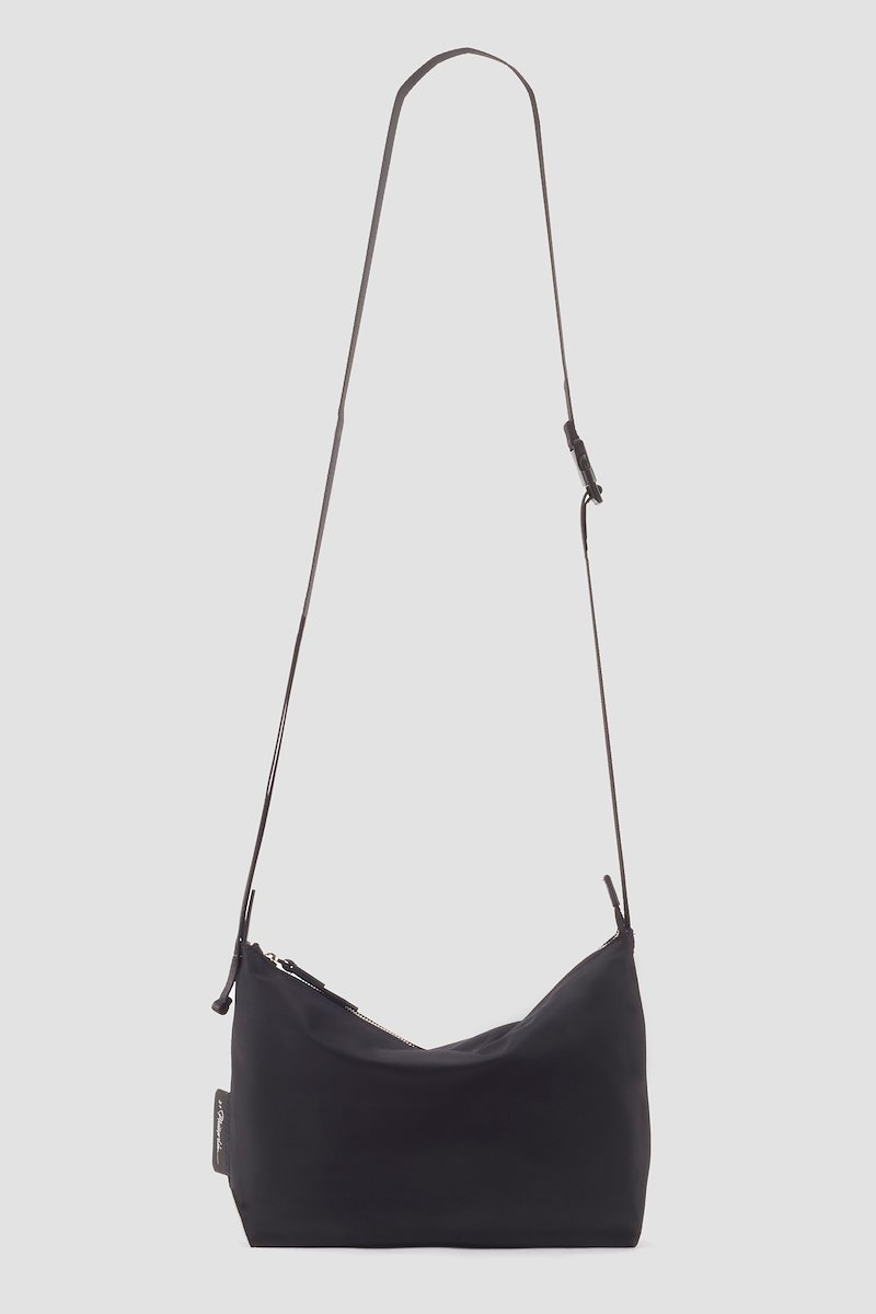 The Deconstructed Sling Bag-black #1 The Deconstructed Sling Bag, Black deconstructed utility sac crossbody bag from 3.1 PHILLIP LIM featuring logo patch to the side, top zip fastening and adjustable shoulder strap.- 1