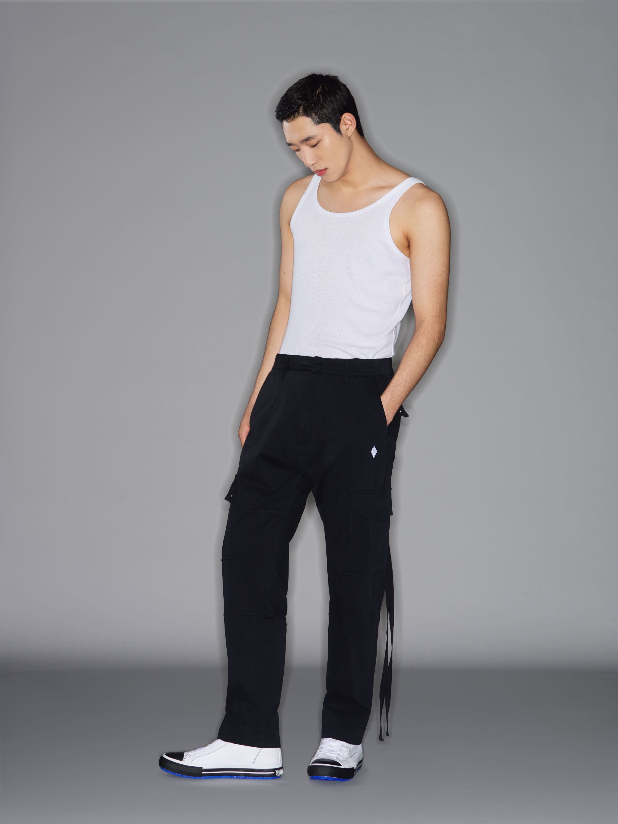 Black cotton Cross embroidered cargo track pants from Marcelo Burlon County of Milan featuring concealed front fastening, belt loops, two side cargo pockets, two rear flap pockets and signature Cross motif.