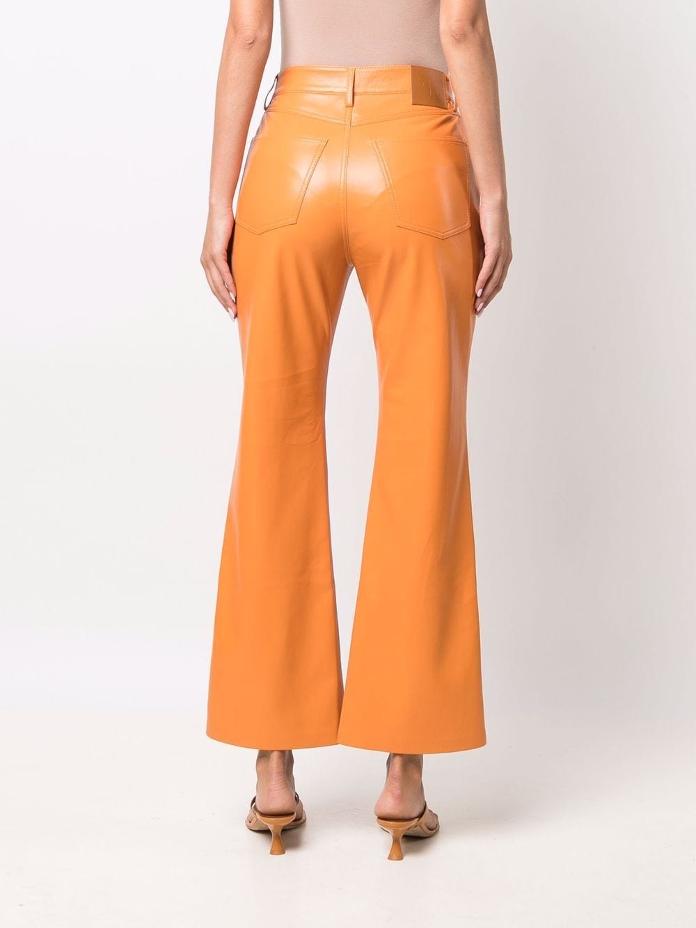 Shop Nanushka Faux-leather Flared Trousers In Orange