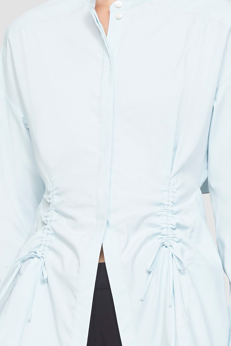 Ruched Tie Front Shirt with Open Back-blue #0 Ruched Tie Front Shirt with Open Back, draped peplum shirt from 3.1 PHILLIP LIM featuring ice blue, draped panel detail, cut-out detailing, lace-up detailing, band collar, concealed front fastening, long sleeves, buttoned cuffs and peplum hem.- 4