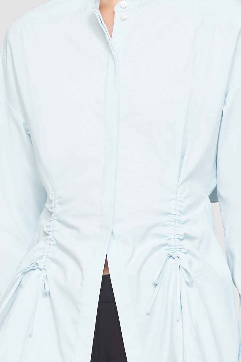 Ruched Tie Front Shirt with Open Back-blue #0 Ruched Tie Front Shirt with Open Back, draped peplum shirt from 3.1 PHILLIP LIM featuring ice blue, draped panel detail, cut-out detailing, lace-up detailing, band collar, concealed front fastening, long sleeves, buttoned cuffs and peplum hem.- 6