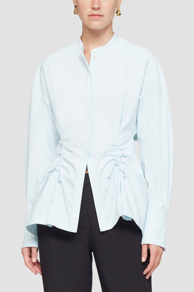 Ruched Tie Front Shirt with Open Back-blue #1 Ruched Tie Front Shirt with Open Back, draped peplum shirt from 3.1 PHILLIP LIM featuring ice blue, draped panel detail, cut-out detailing, lace-up detailing, band collar, concealed front fastening, long sleeves, buttoned cuffs and peplum hem.- 1