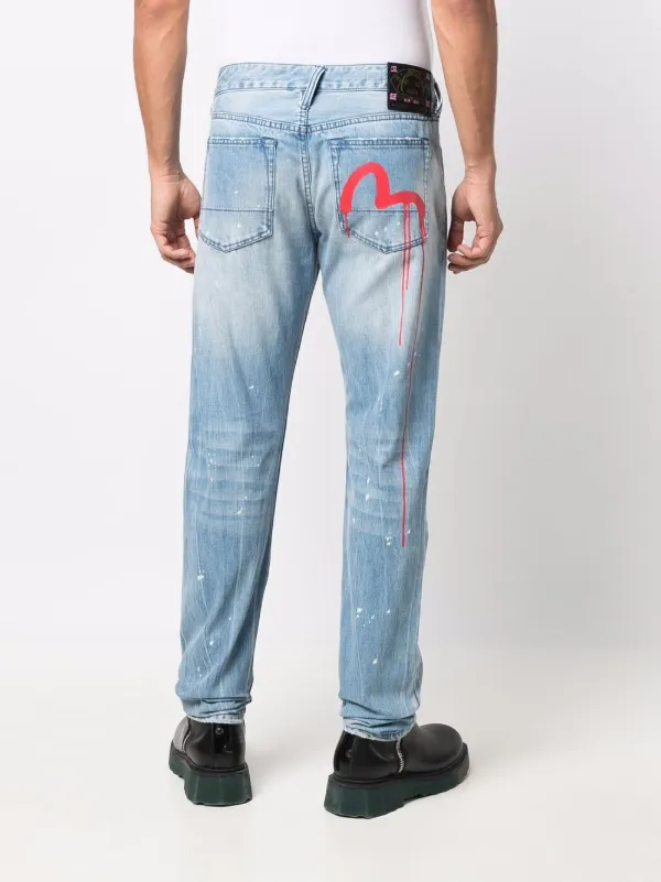 Shop Evisu slim-fit ripped jeans with 