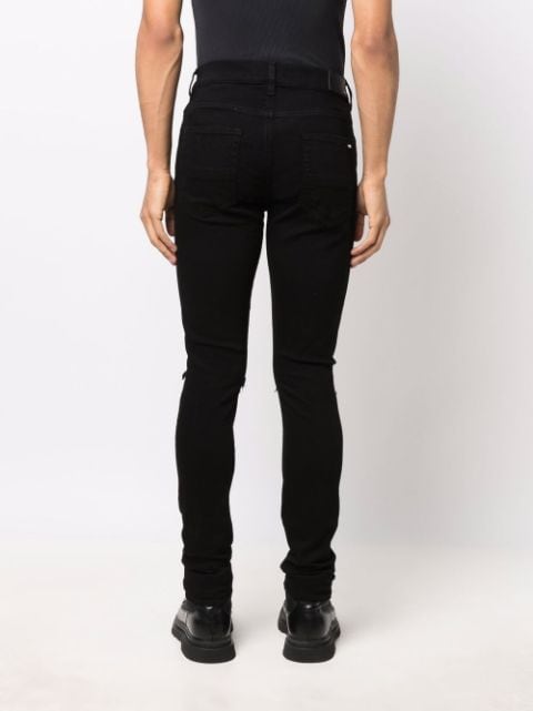 Shop AMIRI ripped-detailing skinny jeans with Express Delivery - FARFETCH