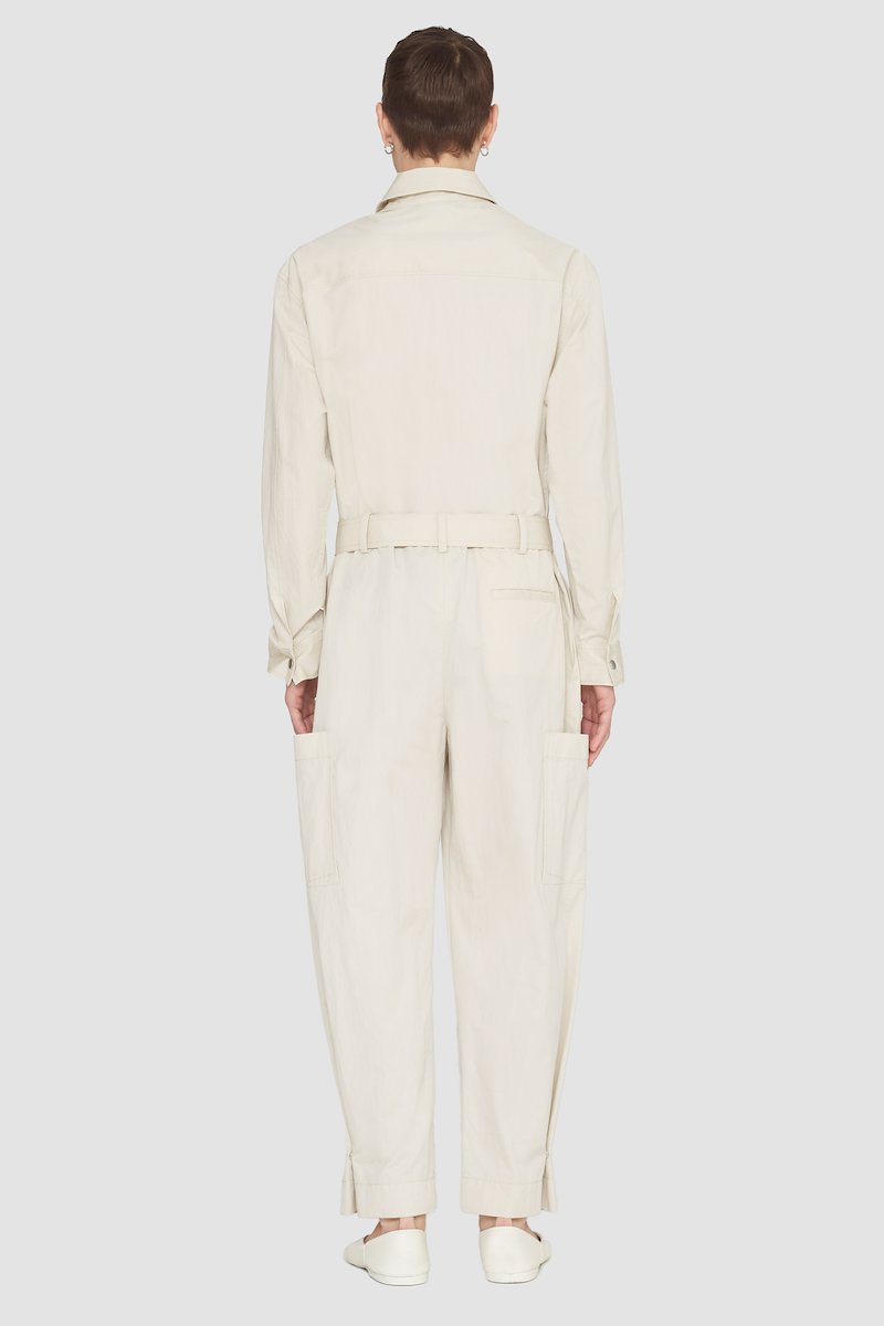 Relaxed Jumpsuit-neutrals #1 Relaxed Jumpsuit, long-sleeve jumpsuit from 3.1 PHILLIP LIM featuring sand beige, cotton blend, concealed front fastening, button-fastening chest pocket, belted waist, two side slit pockets, two side patch pockets, straight leg, classic collar and long sleeves.- 3