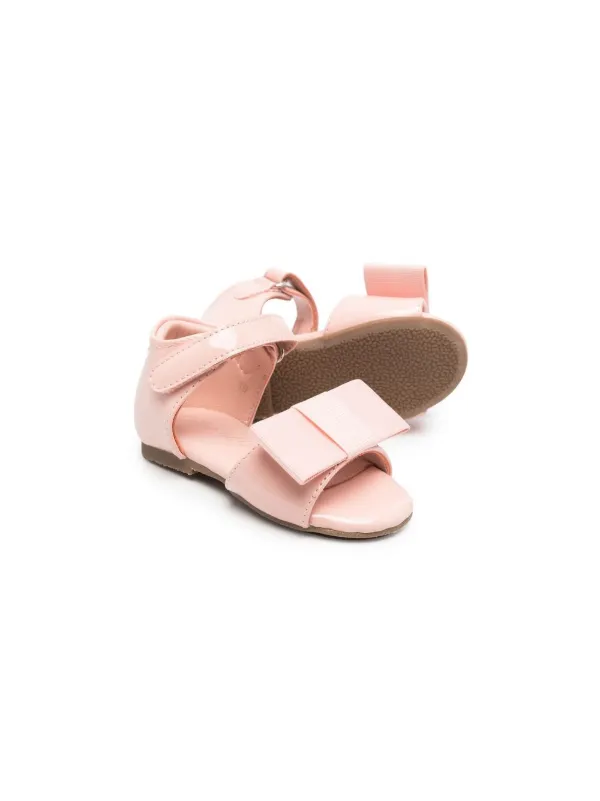 Age Of Innocence bow detail patent leather Sandals Farfetch