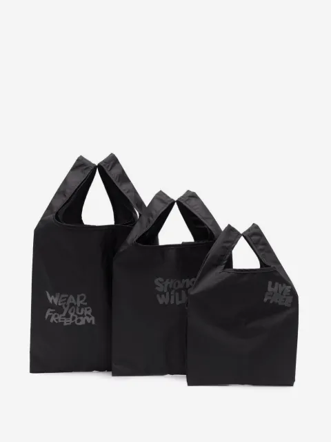 Black Comme Des Garçons tote con eslogan estampado