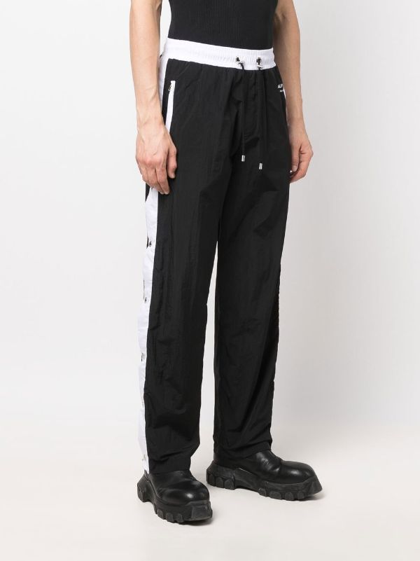 Track pants with discount buttons on side