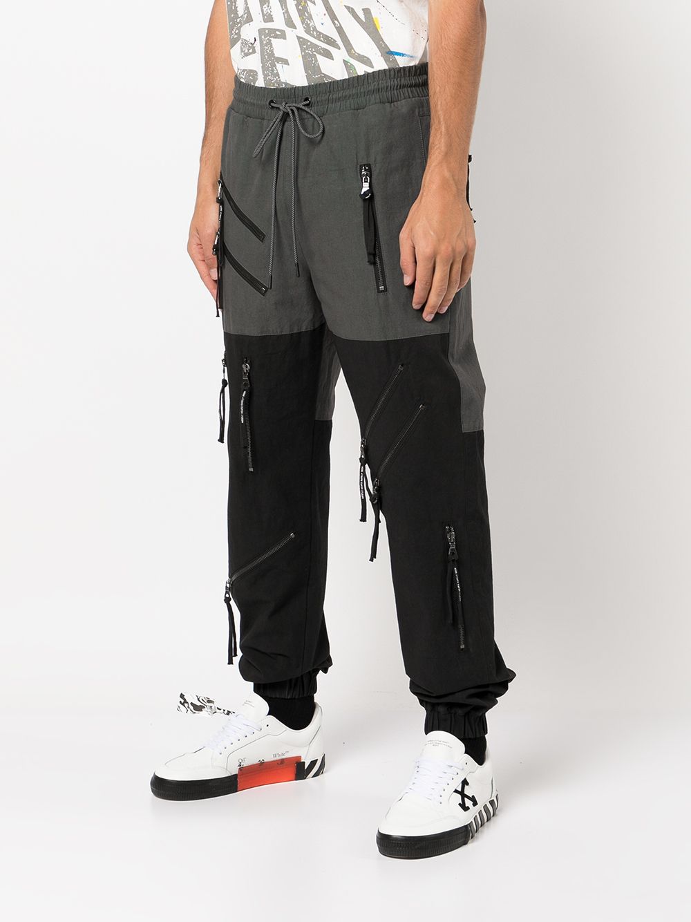 Shop Mostly Heard Rarely Seen Zip-detail Tapered Trousers In Black