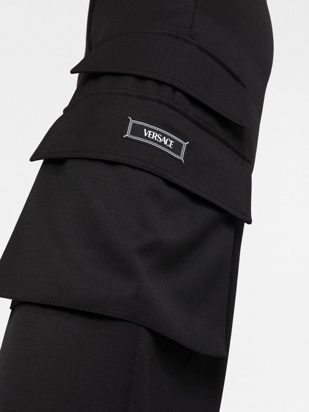 Shop Versace Logo-appliqué Cargo Trousers In Schwarz