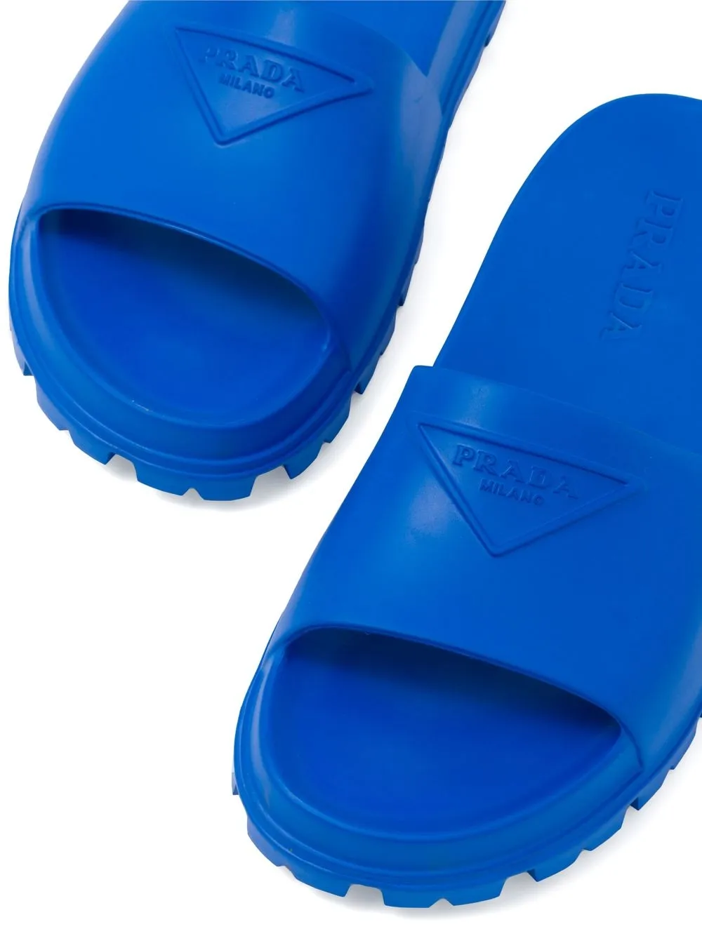 Shop Prada Embossed-logo Open-toe Slides In Blue