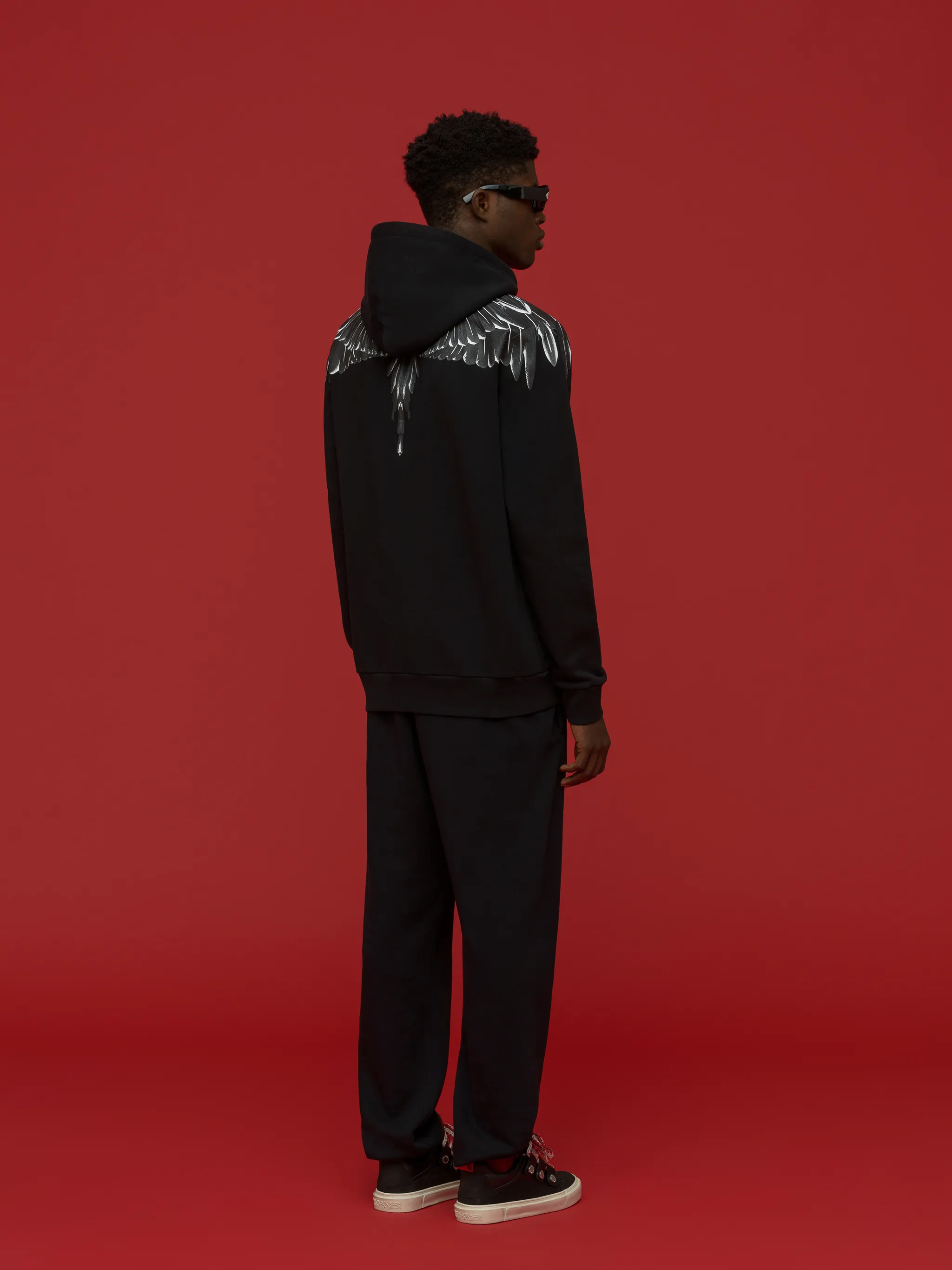 logo-print pullover hoodie from Marcelo Burlon County of Milan featuring black/grey, cotton, logo print to the front, drawstring hood, long sleeves and straight hem.