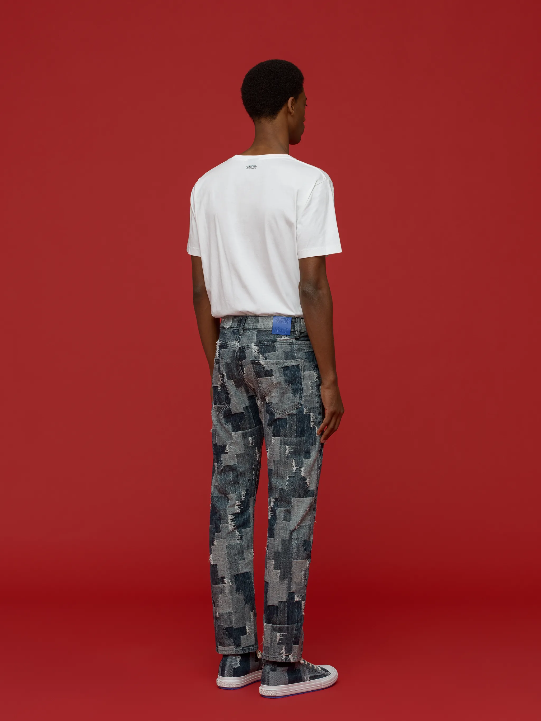 patchwork straight-leg jeans from Marcelo Burlon County of Milan featuring light blue, navy blue, cotton blend, denim patchwork design, logo patch to the rear, front button fastening, two diagonal pockets to the sides and two rear patch pockets.
