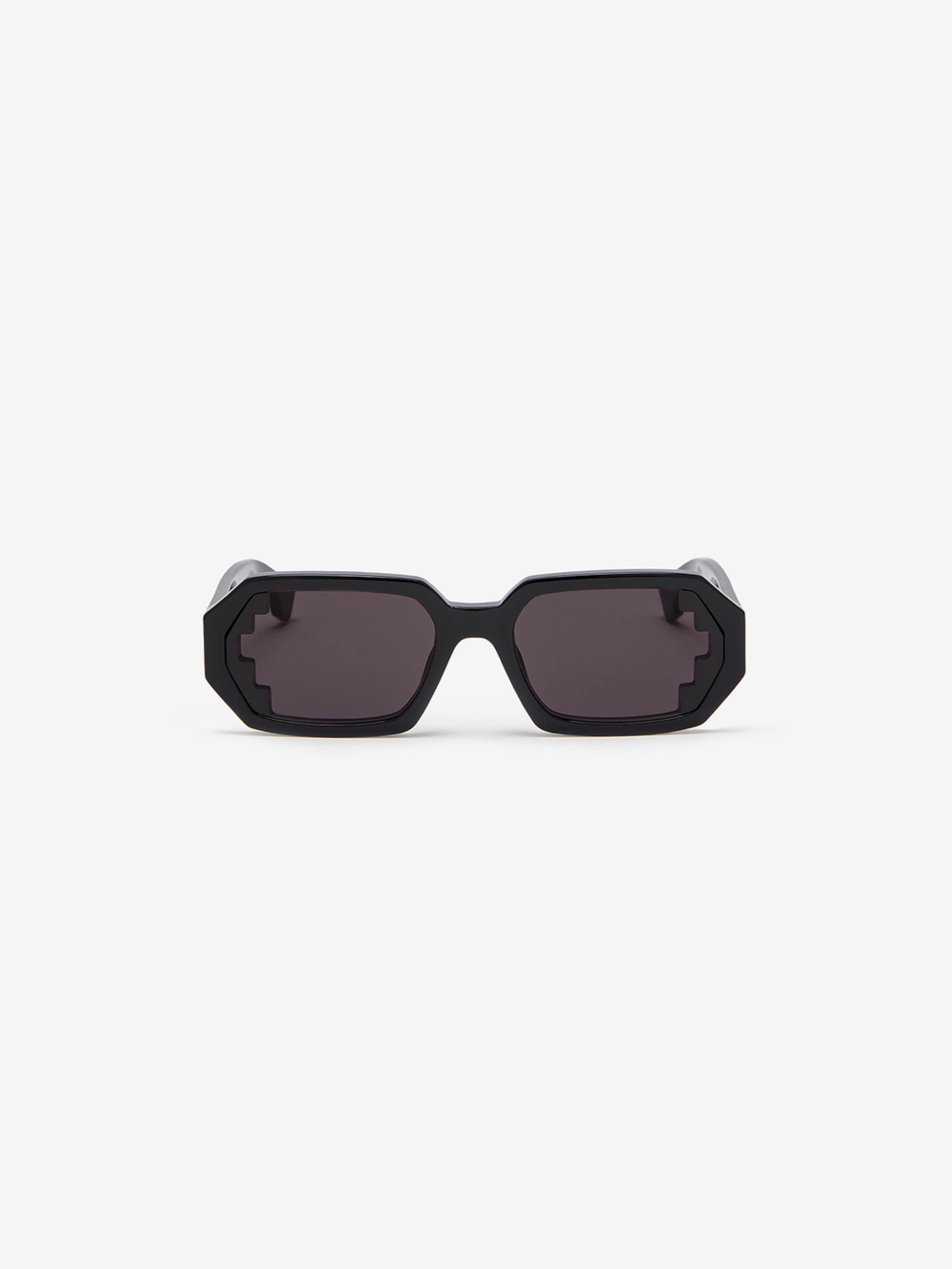 Ombu' geometric frame sunglasses from Marcelo Burlon County of Milan featuring black, geometric frame, grey tinted lenses, signature Cross motif and curved arms. These glasses come with a protective case..