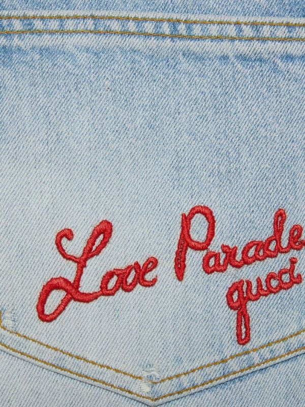 logo-embroidered washed-denim jeans