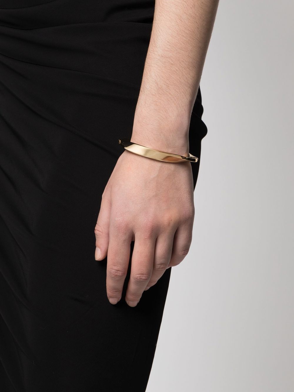 Shop Saint Laurent Twisted Bangle Bracelet In Gold