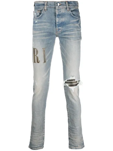 AMIRI logo-print distressed skinny jeans