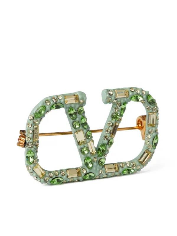 crystal embellished logo brooch