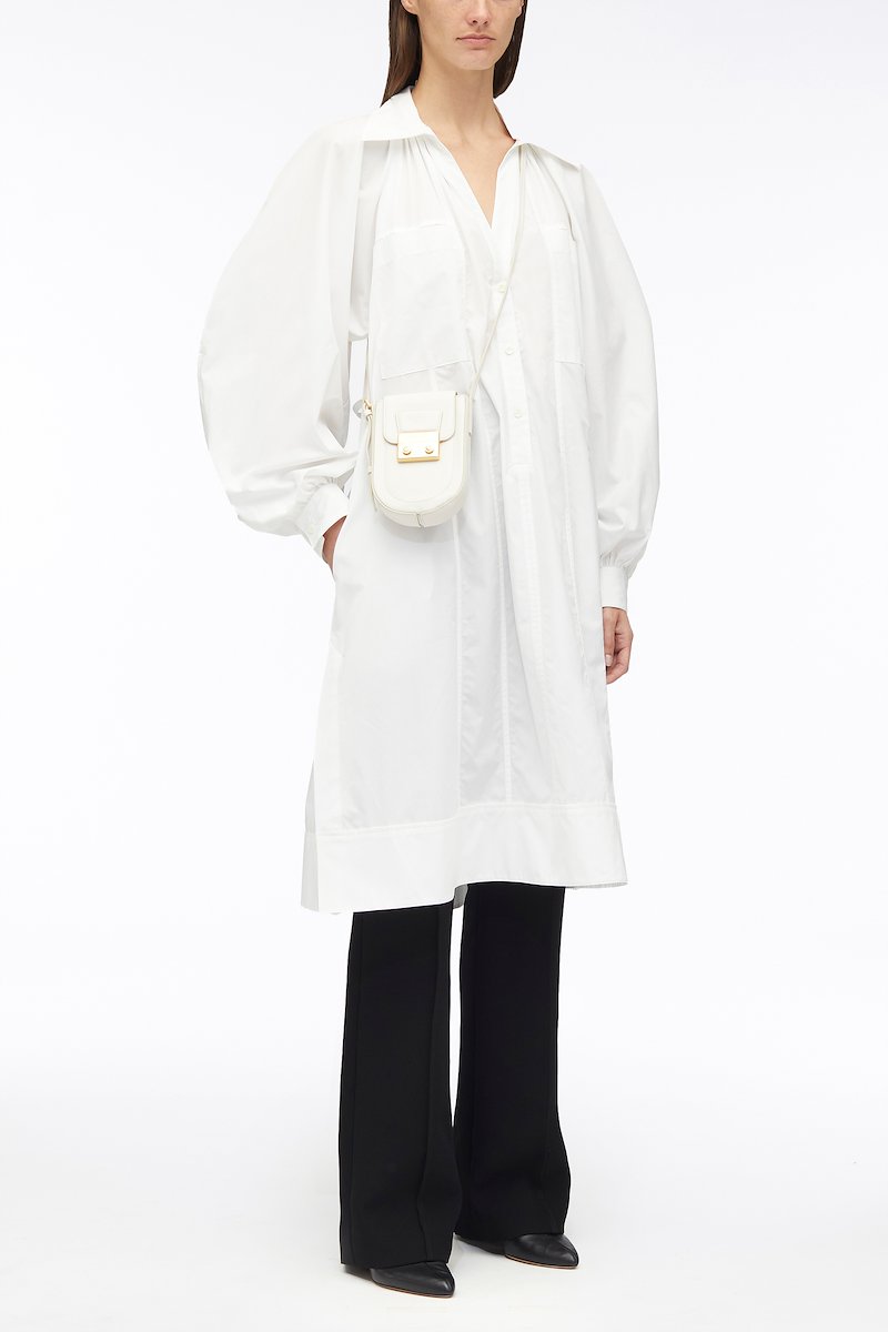 Shirred Puff Sleeve Classic Poplin Shirt Dress-white #0 Shirred Puff Sleeve Classic Poplin Shirt Dress, shirred puff sleeves shirt dress from 3.1 PHILLIP LIM featuring white, cotton, poplin texture, shirred effect, classic collar, V-neck, long puff sleeves, chest patch pocket and below-knee length.- 0