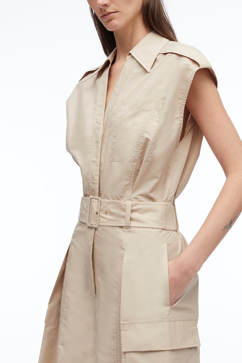 Sleeveless Utility Collared Romper-neutrals #1 Sleeveless Utility Collared Romper, pleat detail belted playsuit from 3.1 PHILLIP LIM featuring sand beige, cotton blend, pleat detailing, belted waist, classic collar, rear elasticated waistband, chest patch pocket, two side flap pockets and short sleeves.- 3
