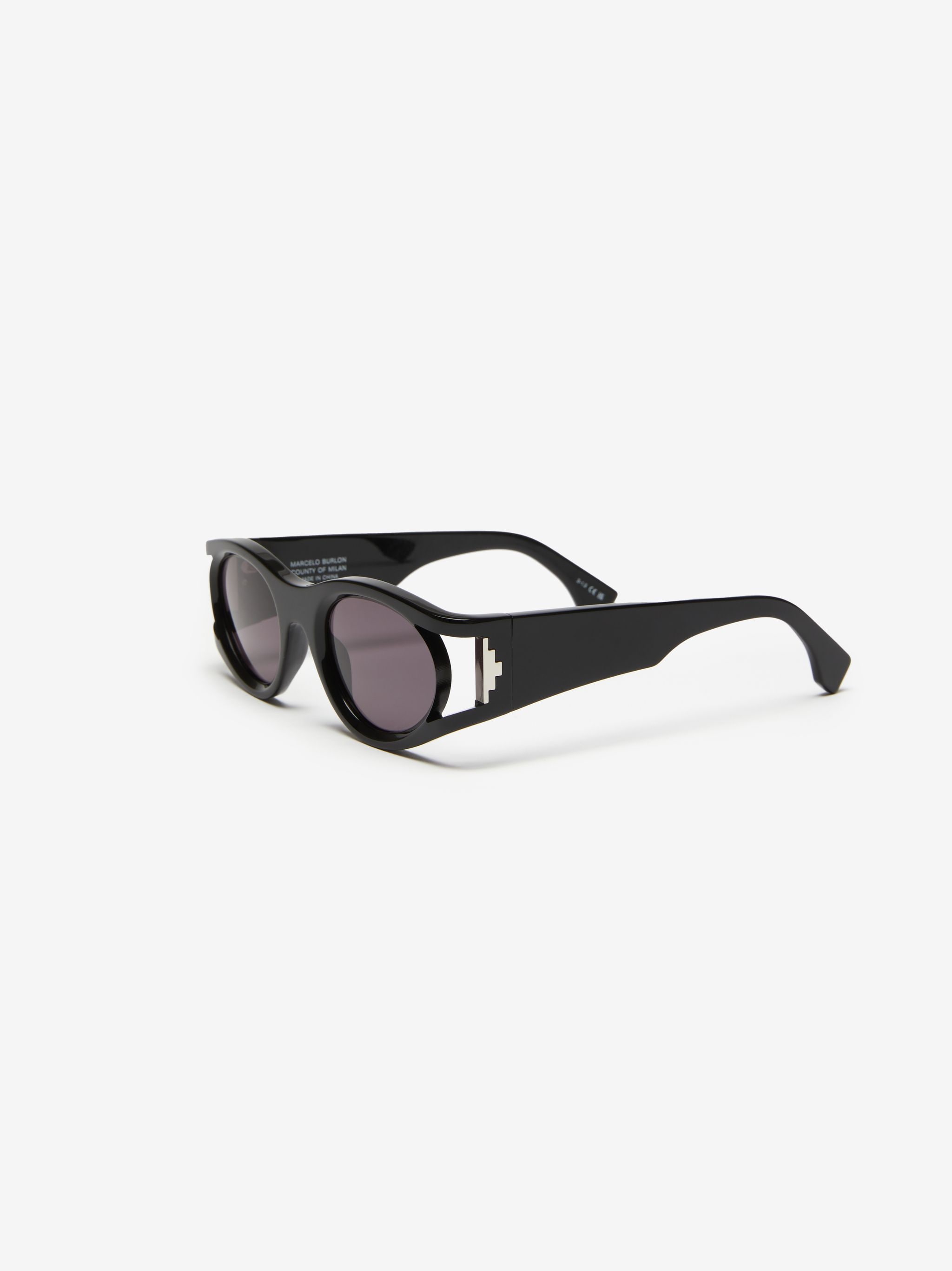 Pasithea round-frame sunglasses from Marcelo Burlon County of Milan featuring black, acetate, glossy finish, grey tinted lenses, UV-protective lenses, round frame, logo plaque at the arm, sculpted arms and curved tips. These glasses come with a protective case..