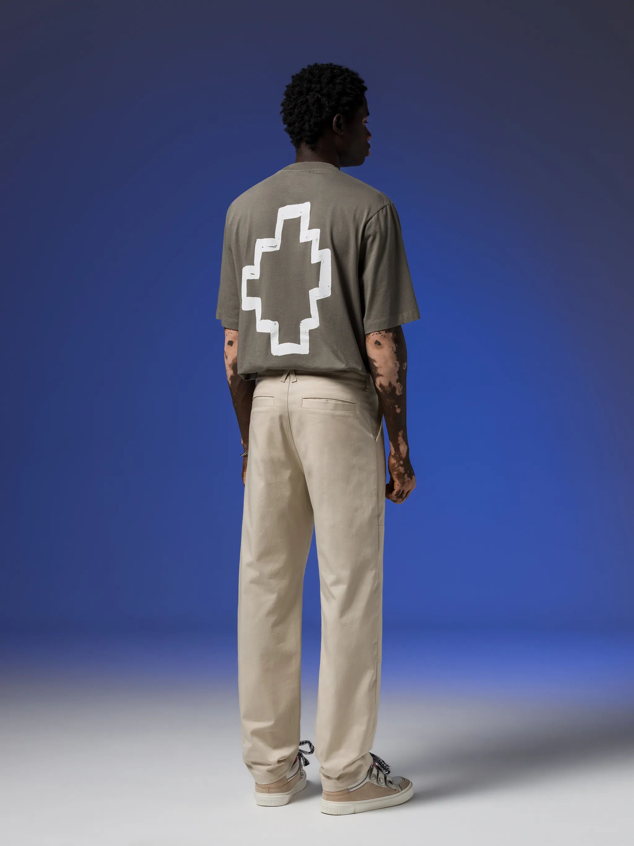 Cross straight tousers from Marcelo Burlon County of Milan featuring light beige, cotton blend, signature Cross motif, mid-rise, belt loops, two diagonal pockets to the sides, two rear welt pockets and straight leg.