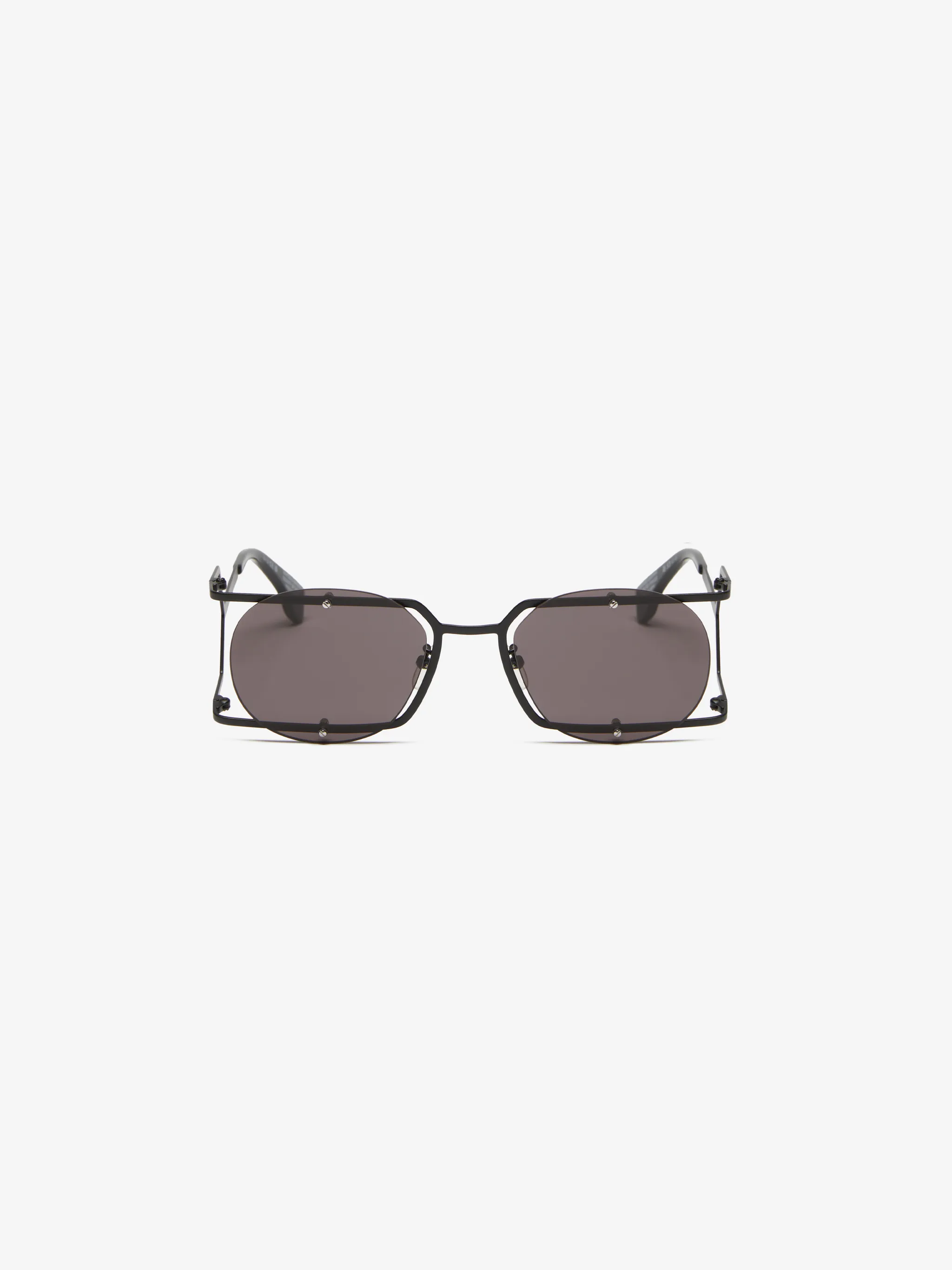 Mutisia round-frame sunglasses from Marcelo Burlon County of Milan featuring black, metal, grey tinted lenses, UV-protective lenses, round frame, square frame, logo plaque at the arm, straight arms and curved tips. These glasses come with a protective case..