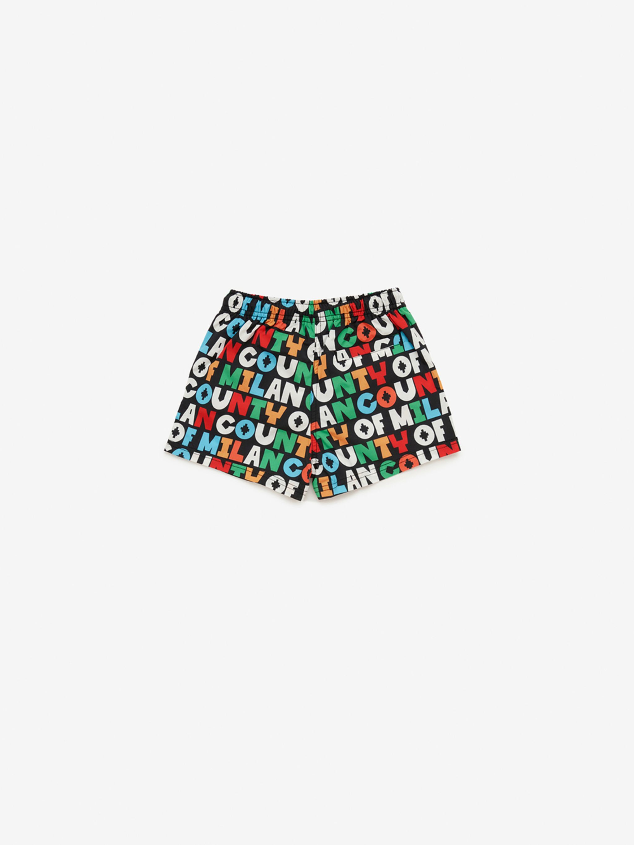 logo-print swim shorts from Marcelo Burlon Kids featuring black/multicolour, all-over logo print, elasticated waistband and thigh-length. Be mindful to try on swimwear over your own garments..