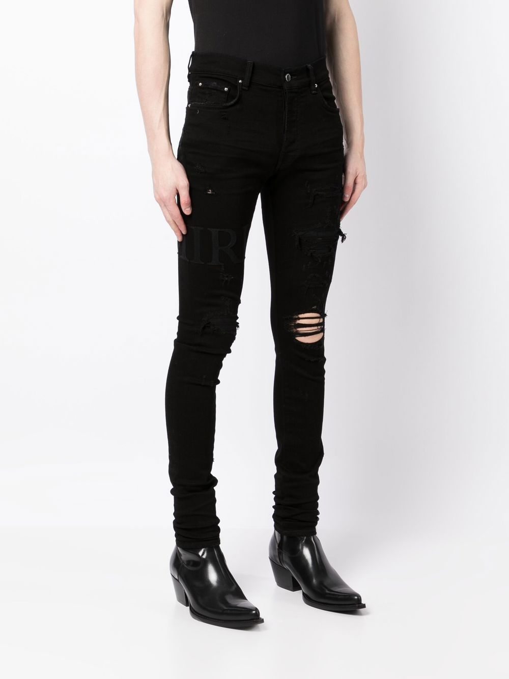 Shop Amiri Ripped-knee Logo-print Skinny Jeans In Black