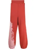 A-COLD-WALL* tie-dye pattern track pants - Red