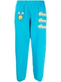 Natasha Zinko Happy-print detail track pants - Blue