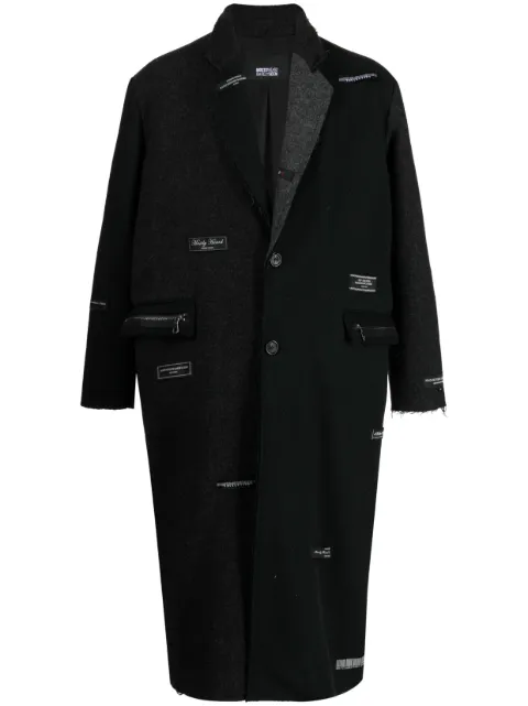 Mostly Heard Rarely Seen gabardina con parches del logo 
