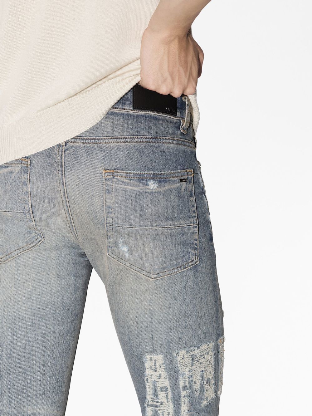 distressed logo skinny jeans