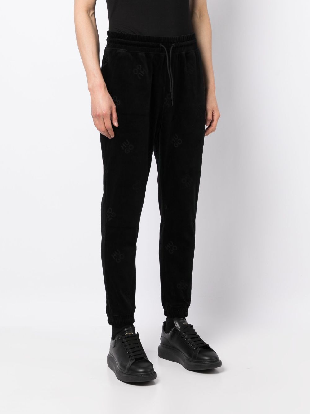 Shop Hugo All-over Logo-print Track Pants In Black