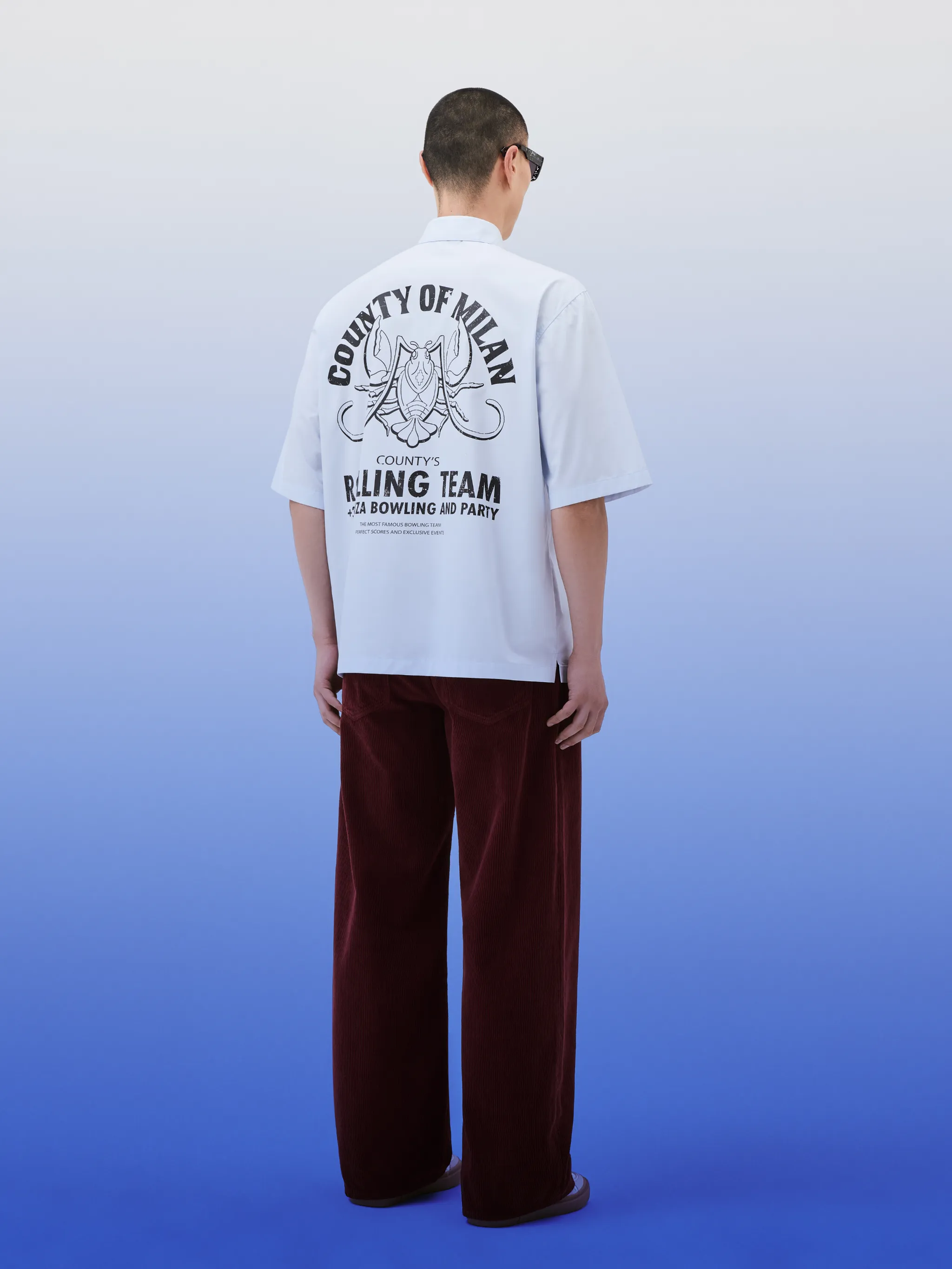 Langosta bowling shirt from Marcelo Burlon County of Milan featuring cotton, logo patch to the front, logo print to the rear, graphic print to the rear, classic collar, front button fastening, short sleeves, chest patch pocket and light blue/black.